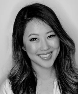Tran Ngo, VP Digital & Growth, True Botanicals
, in a black and white portrait, smiling with long hair and natural makeup.