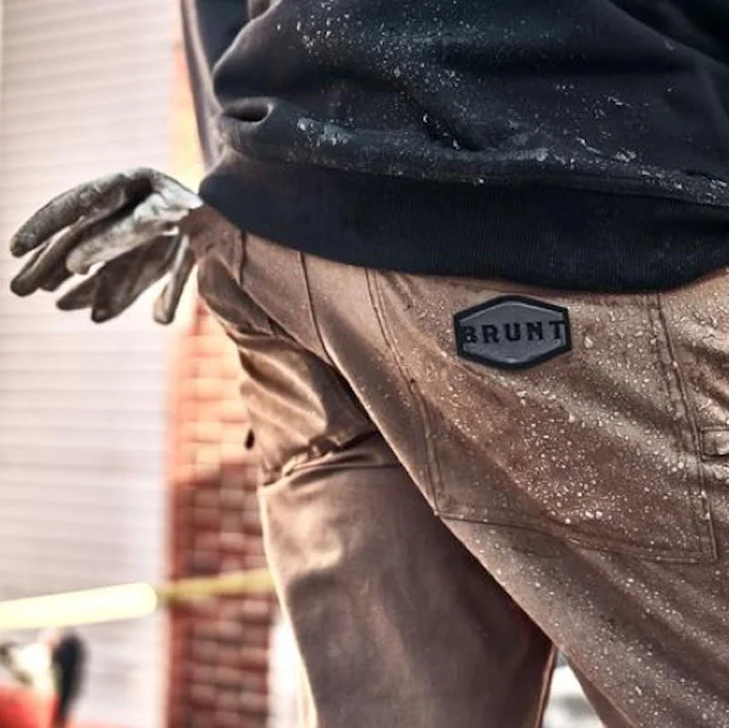 Worker wearing BRUNT Workwear pants and gloves